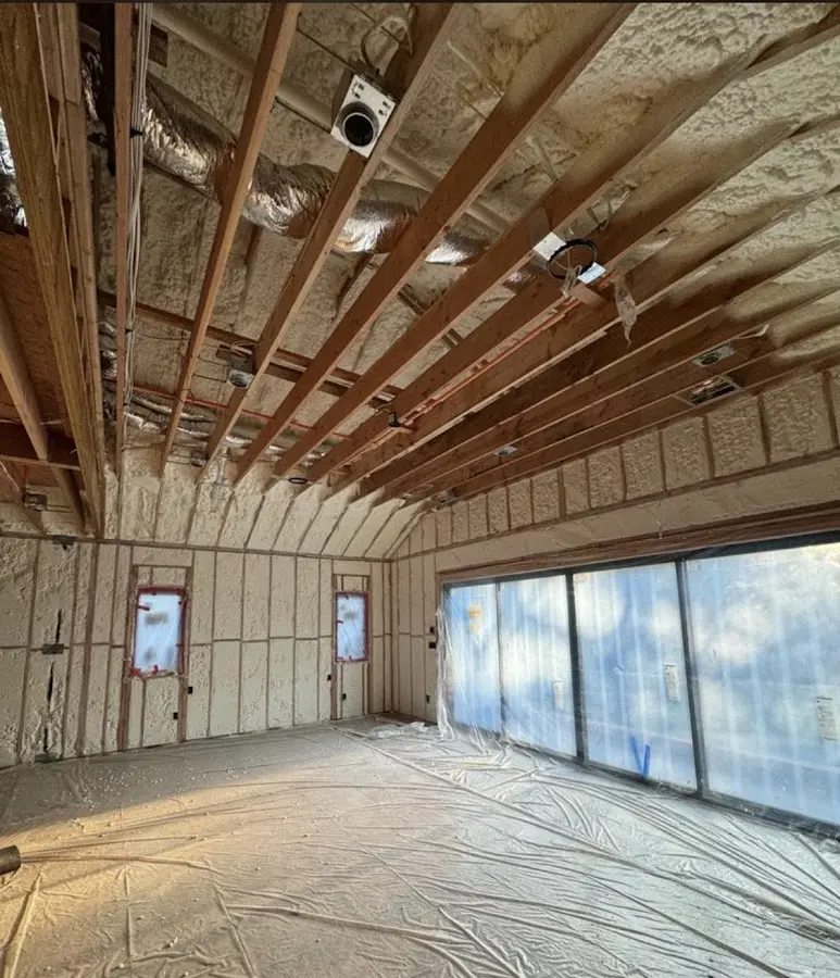 Interior walls and ceiling insulated with spray foam during new construction in Byron